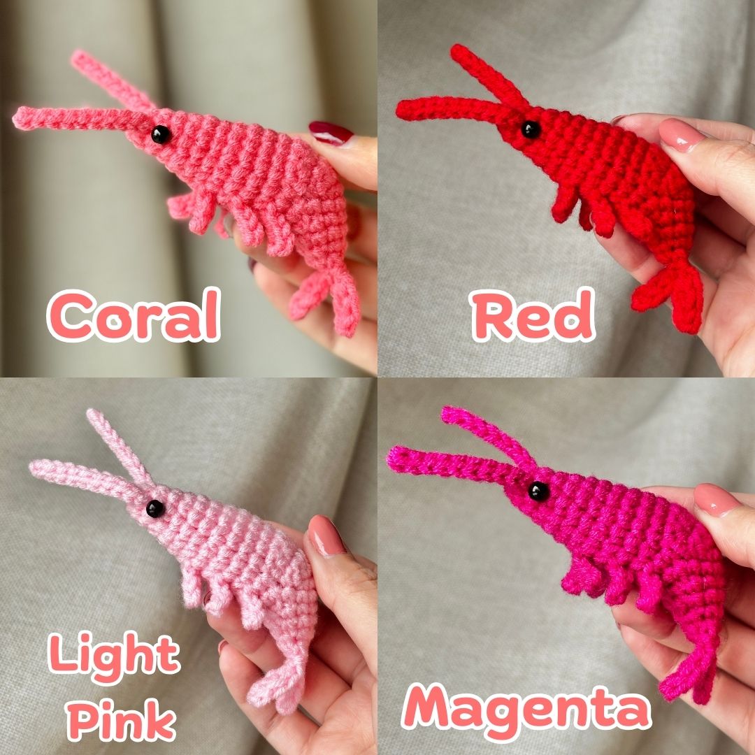 Four crochet shrimp toys in different colors held by hands against a neutral background.